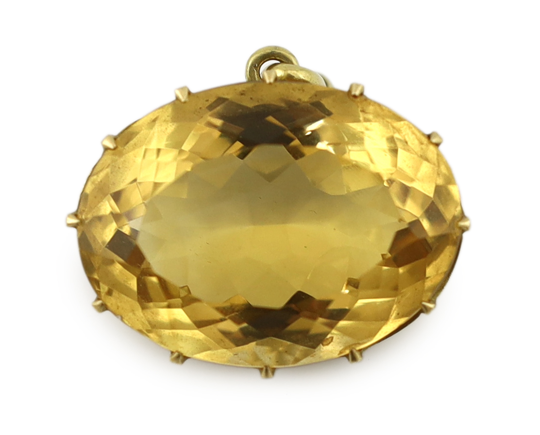 A large gold mounted oval cut citrine set pendant